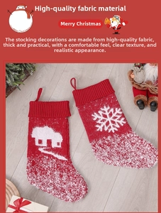 Detail of red and white knitted Christmas stockings with snowflake and house patterns