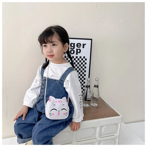 Toddler girl wearing a mini white cat-shaped PU leather crossbody bag with thin strap