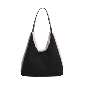 Contrast color black and white shoulder tote bag with faux fur trim on white background