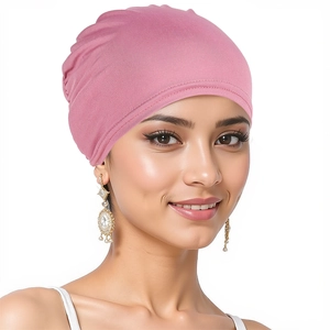 Close-up of pink knitted turban hat showing soft texture and elastic fit for women