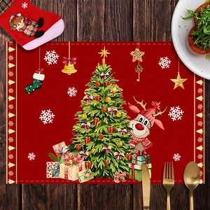 Close-up of a festive red Christmas placemat with reindeer and tree on wooden table