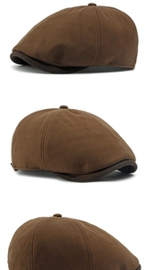 Detail of vintage brown newsboy cap with herringbone pattern and contrast visor