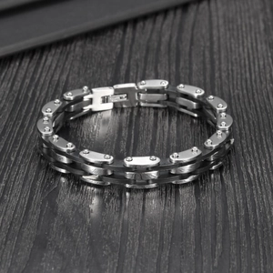 Detailed view of retro multilayer silicone and stainless steel bracelet on wood surface