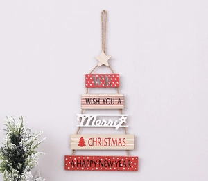 Detail of wooden Christmas tree wall hanging with festive greetings and snowflake decor