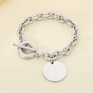 Detail of 9mm stainless steel cable chain bracelet with round disc and OT toggle clasp
