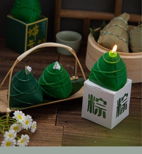 Detail of green Zongzi shaped scented candle with traditional Dragon Boat Festival gift box