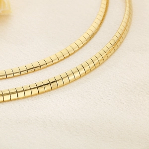 Macro shot of gold-plated 18K titanium steel snake chain with smooth metallic shine