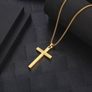 Minimalist gold cross necklace with radiant engraved lines on a black background
