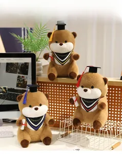 Close-up of graduation otter plush with black mortarboard and Congratulations scarf