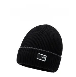 Close-up of thick ribbed knit texture and NY&JA fashion label on the black beanie
