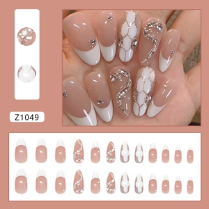 Sparkly almond-shaped press-on nails with snake scale pattern and luxury rhinestone accents