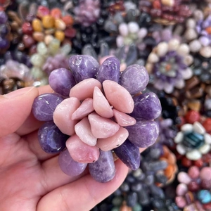 Close-up of handmade purple and pink crystal flower made from polished tumbled gemstones