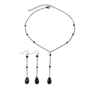 Detail of gothic black beaded jewelry set featuring drop tassel necklace and earrings