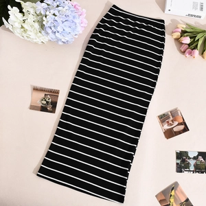 Detailed view of black and white striped knit midi skirt with ribbed texture fabric