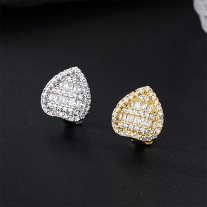 Macro detail of triangle hip hop stud earrings with gold plating and cubic zirconia inlay