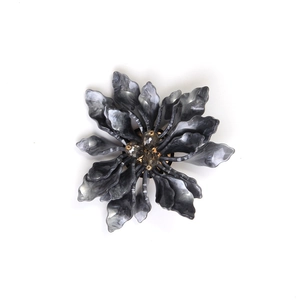 Detail of grey marble acrylic flower brooch with brown faceted beads and elegant fringe
