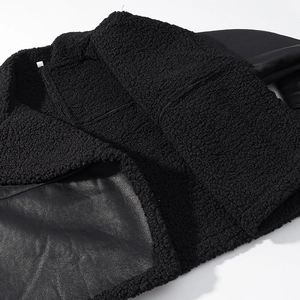 Detail of black faux leather and shearling lining collar on a belted winter jacket