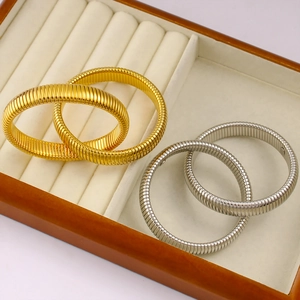 Close-up of gold and silver elastic coiled bracelets with detailed spiral texture