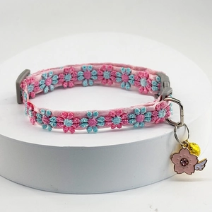 Pink pet collar detail with floral lace, sakura pendant, bells and wing decorations