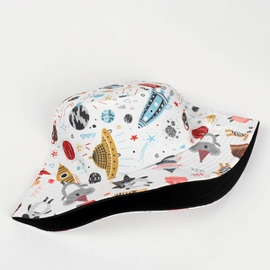 Detailed close-up of white reversible bucket hat with colorful cartoon space and rocket prints