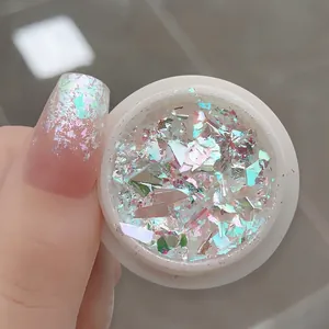 Macro view of opal nail powder showing iridescent aurora glitter effect on fingertips
