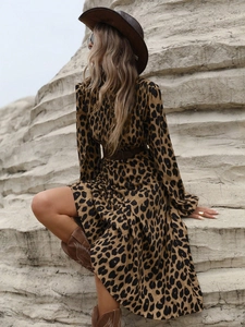 Detail of leopard print maxi dress styled with western boots and a rancher hat