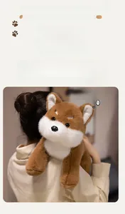 Detail showing plush Shiba Inu toy's soft fur and cute face resting on a shoulder