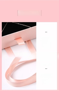 Pink drawer jewelry box with silk handle and black velvet lining for necklaces