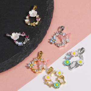Macro detail of cubic zirconia butterfly pendants with pearls and shell flower charms