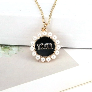Golden pearl necklace featuring a lucky 11:11 number pendant with black drip oil finish