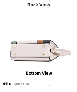 Detail of color-block handbag bottom with four protective metal feet and leather texture