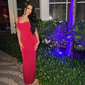 Detailed back view of a slim-fit red maxi dress with bow accents in an outdoor setting