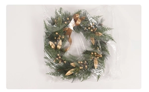 Detail of handcrafted Christmas wreath with gold berries, leaves and pine needles