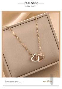 Close-up of interlocking rose gold heart pendants with fine zircon stones in a gift box