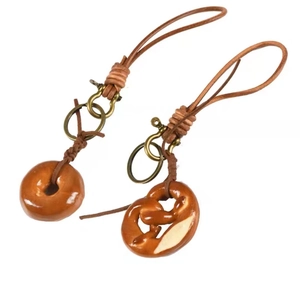 Handmade leather rope keychain with brown donut and pretzel resin charms and metal rings