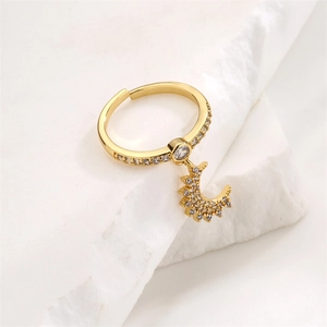 Detail of gold-plated crescent moon ring with micro-pave cubic zirconia on stone base