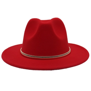 Detail of red wide brim fedora hat featuring a stylish gold metal band accessory