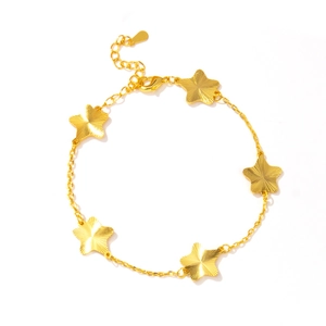 Detail showing five-pointed stars with a brushed texture on a gold-tone chain bracelet