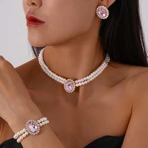 Detailed view of luxury double-row pearl jewelry set with pink oval crystal pendants