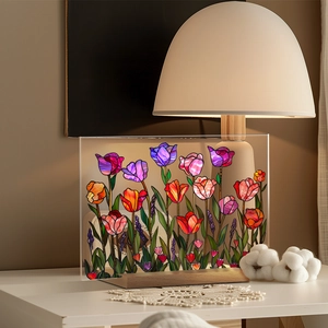 Detailed close-up of a faux glass tulip acrylic plaque on a natural wooden base
