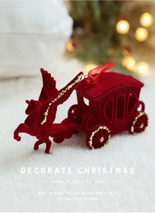 Detail of red flocked reindeer sleigh ornament with gold glitter accents and silk cord