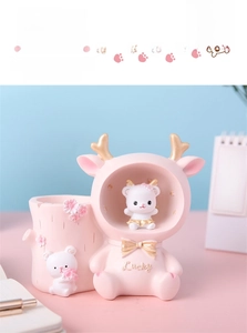 Close-up of pink bunny pen holder with lucky bear and carved cherry blossoms