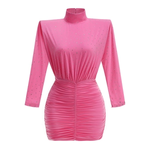 Detailed view of pink long sleeve mini dress featuring rhinestones and pleated texture