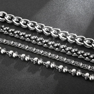Detailed macro shot of vintage gothic skull charms on stainless steel chains for men