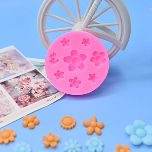 Detail showing pink silicone flower mold with daisy shaped fondant finished pieces