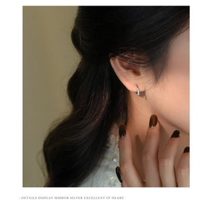 Close-up of elegant S925 silver hoop earrings with sparkling cubic zirconia on model