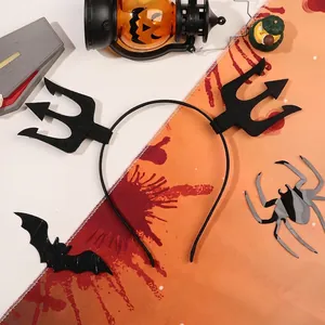 Detail of black Halloween devil horn headband with trident decor on a festive background