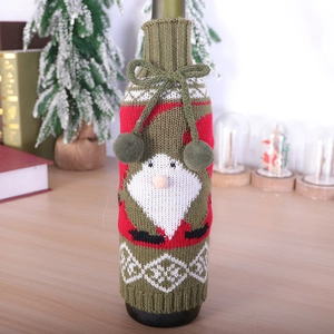 Knitted Christmas gnome wine bottle cover in red and green with a decorative pom-pom