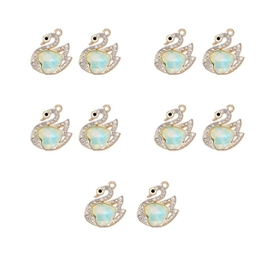 Detailed set of 10 golden swan pendants with iridescent heart stones and clear rhinestones