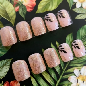 Short square press-on nails with champagne gold glitter and elegant floral leaf patterns
